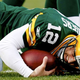 Illustration for article titled Everyone In Huddle Afraid To Tell Aaron Rodgers About Turf Stuck In Teeth
